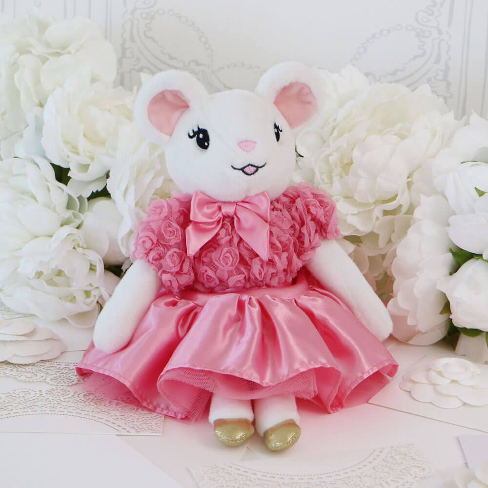 Claris the Mouse plush doll sitting with white ruffled roses behind her
