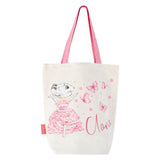 A canvas tote bag with pink straps and a illustration of a character named Claris, accompanied by butterflies, on a white background.