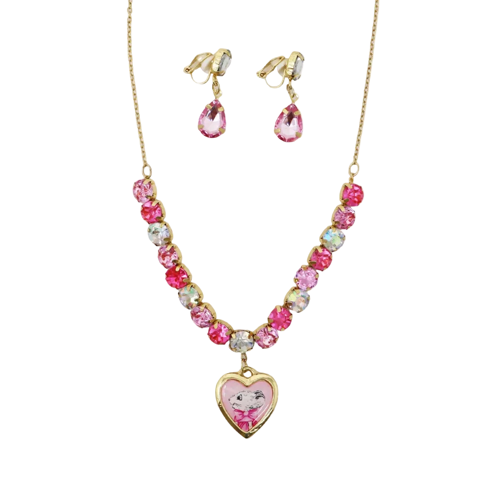 A children's jewelry set featuring a gold-tone necklace and matching clip-on earrings. The necklace has a heart-shaped pendant with a cartoon girl illustration, and the chain is decorated with pink, clear, and iridescent rhinestones.