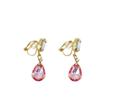 A pair of gold clip-on dangle earrings featuring faceted pink teardrop gemstones, shown against a plain white background.