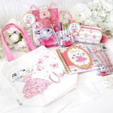 Claris tote bag with a selection of claris stationary surrounding it