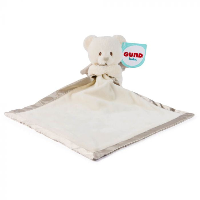 A Gund Baby security blanket featuring a cream-colored plush teddy bear attached to a square soft fabric pad with a gray satin border, shown on a plain white background with its Gund Baby brand tag visible.
