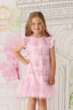 Young girl wearing a pink Claris dress with Claris the mouse pattern against a decorative wall.
