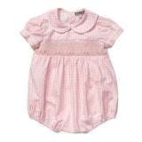 A pink and white gingham baby romper with a smocked chest panel and embroidered bow details, featuring a Peter Pan collar and short puff sleeves.