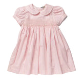 A pink and white gingham baby girl's dress with a smocked bodice, short puff sleeves, and a Peter Pan collar, shown flat on a light gray background.