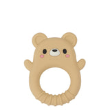A beige silicone baby teether shaped like a bear face with a circular ring handle, featuring black eyes, a white snout, and pink cheeks, shown on a light gray background.