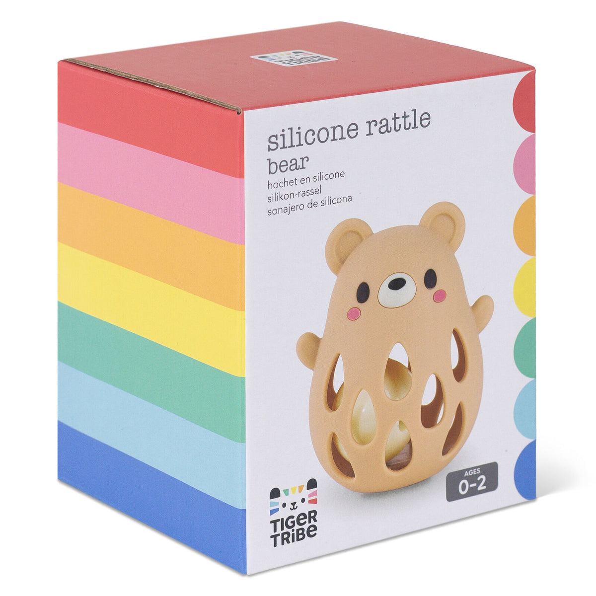 Tiger Tribe silicone rattle bear toy in its original packaging, featuring a white box with a colorful rainbow stripe pattern on the left side and an illustration of the beige bear rattle on the front.