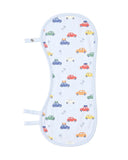 A baby burp cloth that turns into a bib with a white background and a colorful pattern of cartoon cars and palm trees, featuring light blue trim and snap closures on the sides.