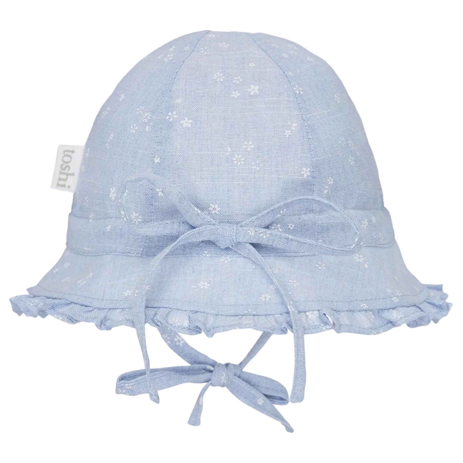 A light blue fabric baby sun hat with a white floral pattern, featuring a wide brim with ruffled trim, a matching bow on the front, and chin ties. A small fabric tag on the side reads 'loohi'.