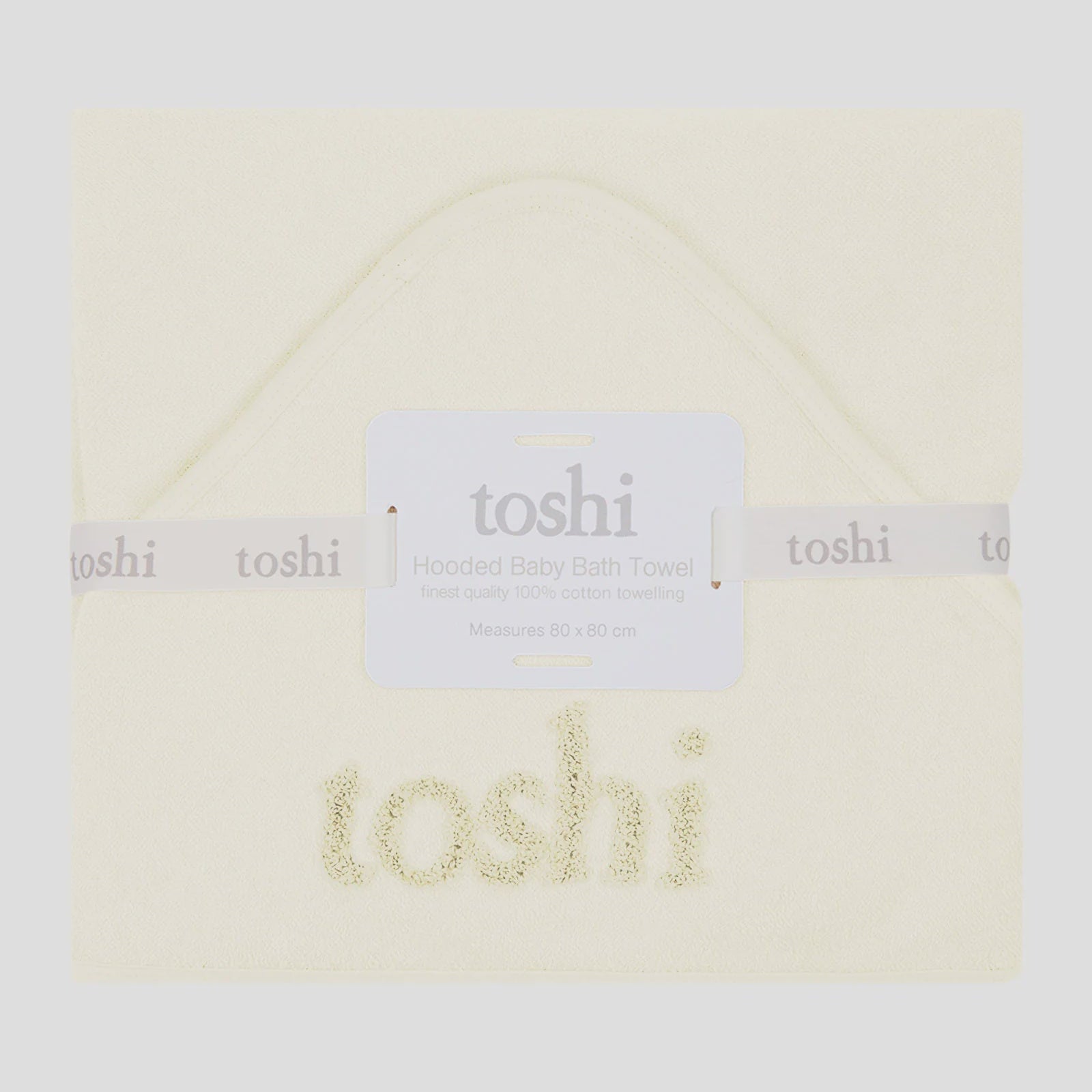 Folded baby blanket with 'toshi' branding on a white background