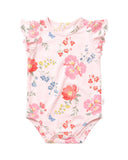 A baby bodysuit in light pink with a watercolor floral print featuring red, pink, blue, and yellow flowers, green leaves, and small blue butterflies. It has ruffled cap sleeves and a snap closure at the bottom.