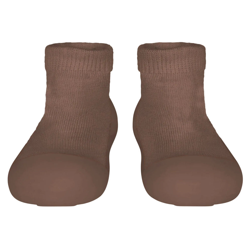 Pair of brown sock shoes on a light gray background