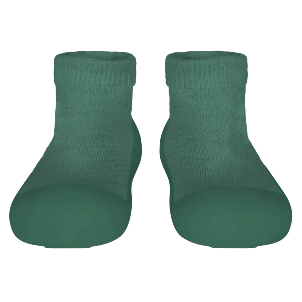 Pair of green sock shoes on a light gray background