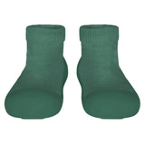 Pair of green sock shoes on a light gray background