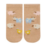 Pair of socks with farm animal pattern on a beige background