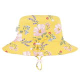 A yellow bucket hat with a pink, blue, and green floral pattern, featuring a drawstring chin strap, shown against a plain white background.