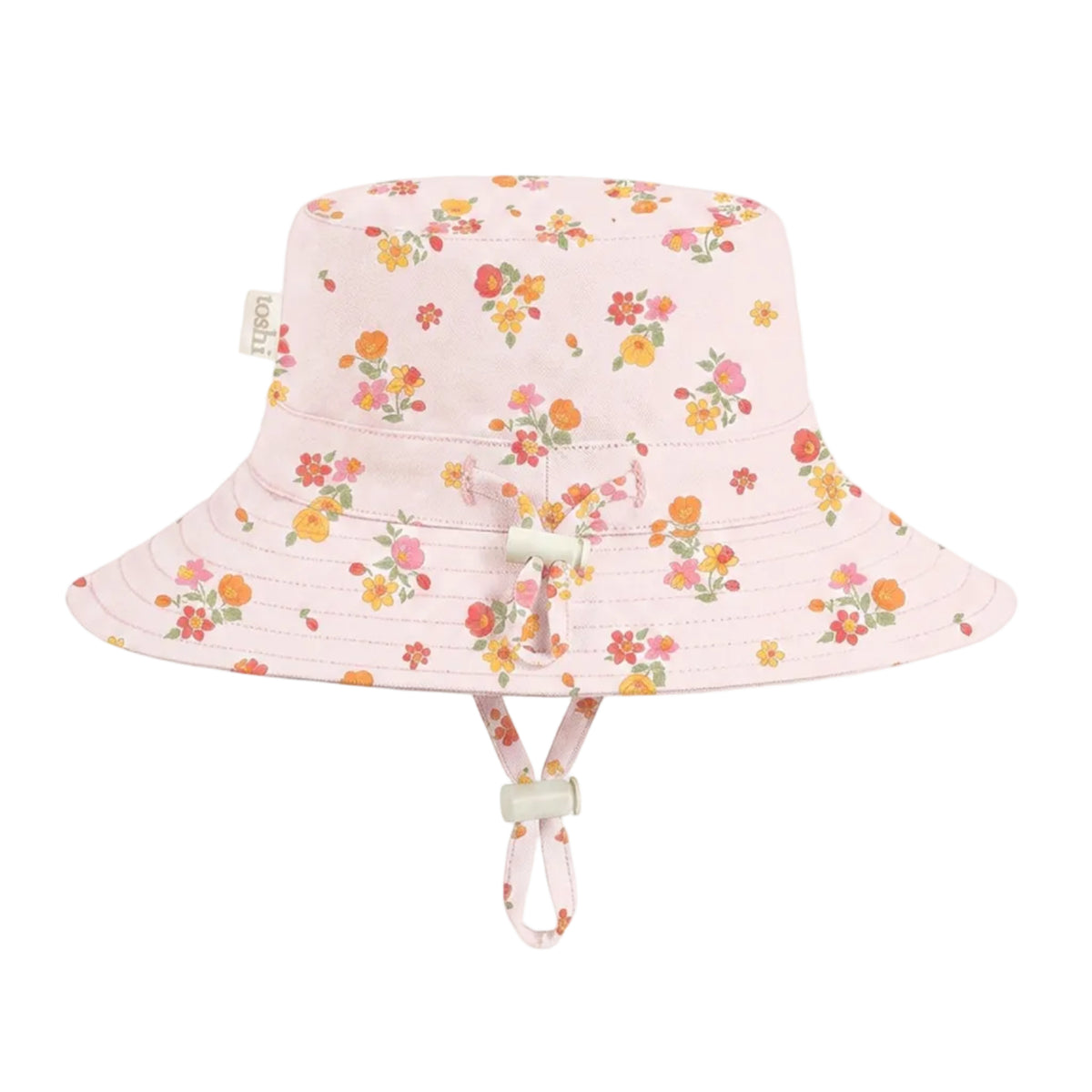 A light pink bucket hat with a colorful floral print, featuring a chin strap and a small bow on the front, set against a plain light gray background.