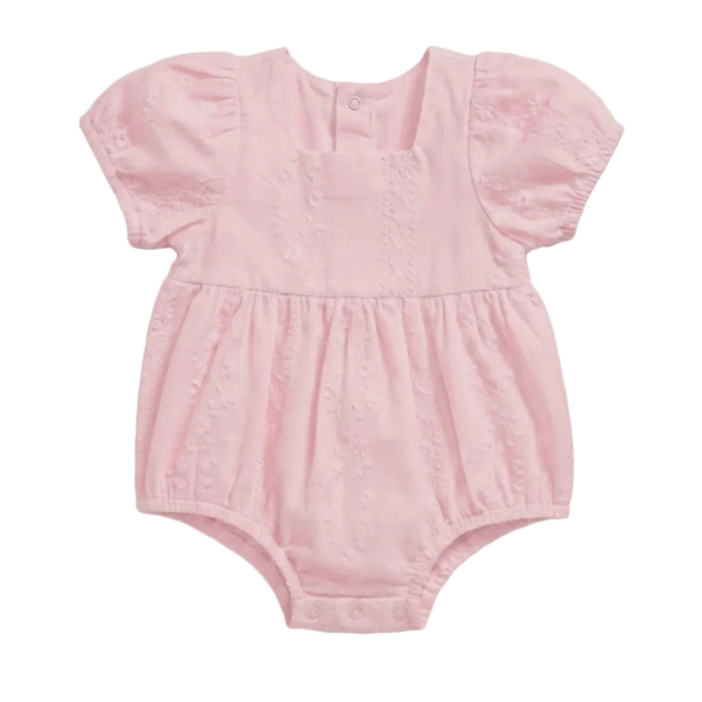 A light pink baby romper with short puff sleeves, a gathered waist, and a textured eyelet fabric, shown against a plain light gray background.