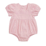 A light pink baby romper with short puff sleeves, a gathered waist, and a textured eyelet fabric, shown against a plain light gray background.