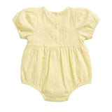 A pale yellow baby romper with short puff sleeves, a buttoned back, and a gathered waist, shown flat on a light gray background.