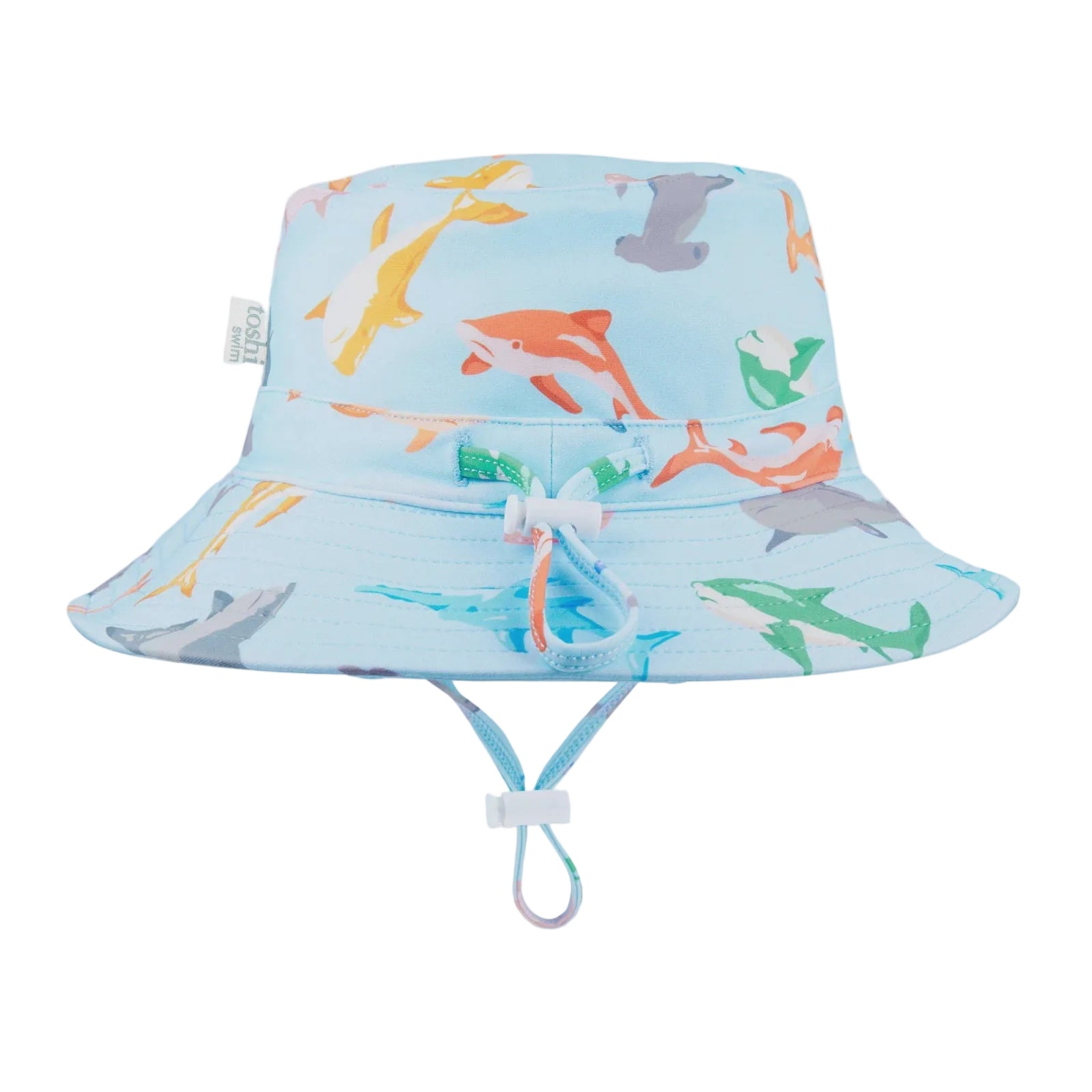 A blue and white baby sunhat with a shark pattern, featuring a head tie and chin strap for adjustable fitting, labeled with 'UPF50+' for sun safety.
