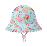 A light blue baby bucket hat with a colorful floral print, featuring a ruffled brim and a matching chin strap with a pink toggle, shown against a plain light gray background.