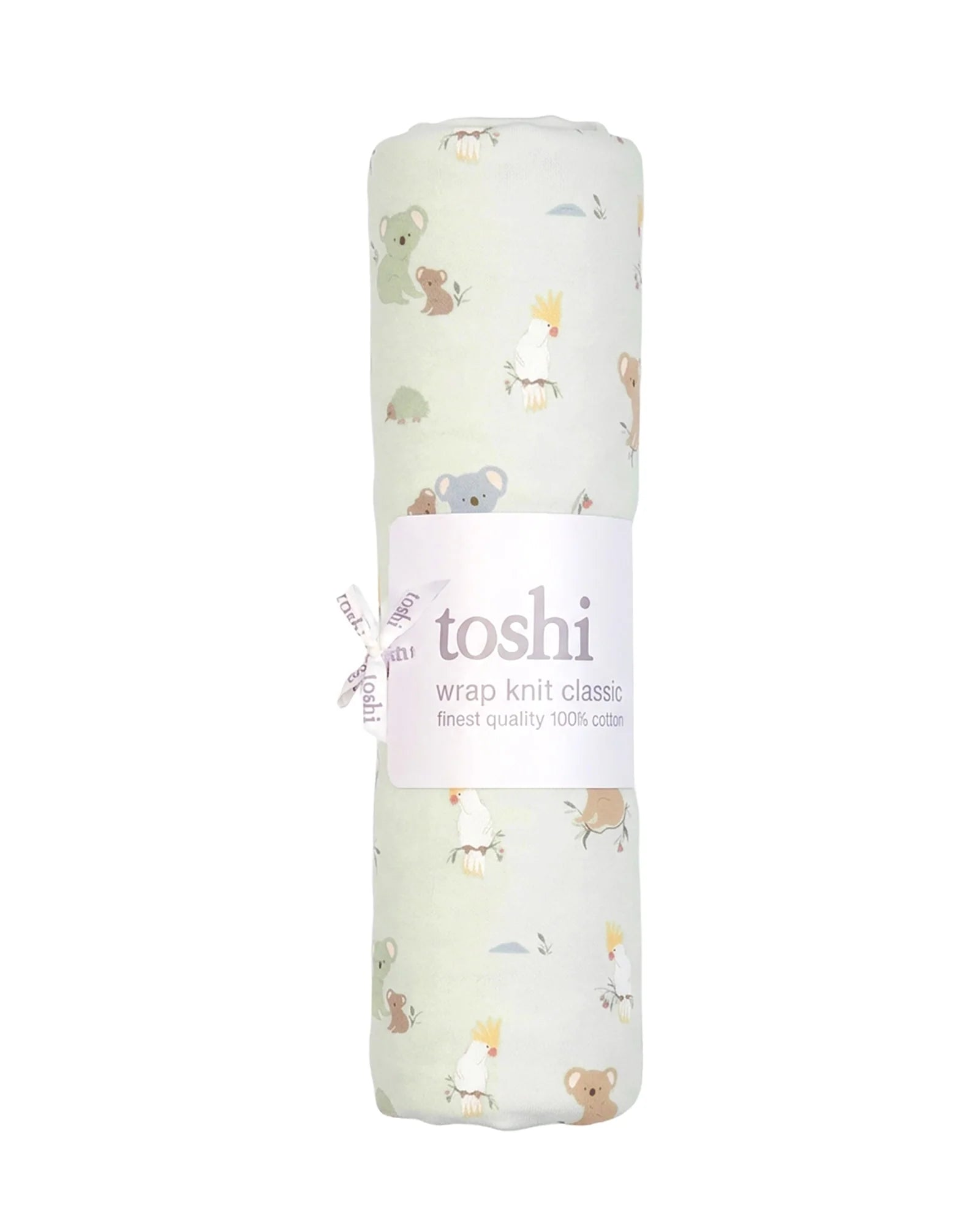 A folded knit baby blanket with a light sage green background and a playful pattern of cartoon koalas, kangaroo babies, and birds in soft pastel colors, shown on a neutral light gray background.