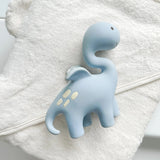 Blue dinosaur teething toy on a white towel