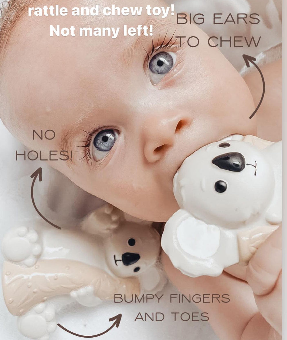 Baby doll with  Koala teether and text highlighting features like 'big ears to chew' and 'bumpy fingers and toes'.